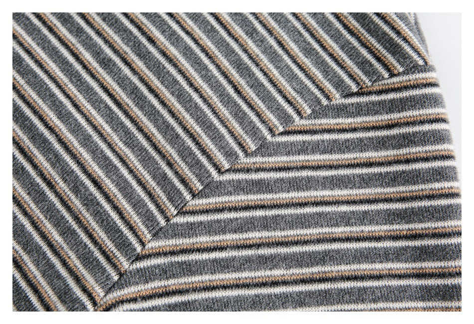 Close-up of gray knit stripes meeting at an angled seam.