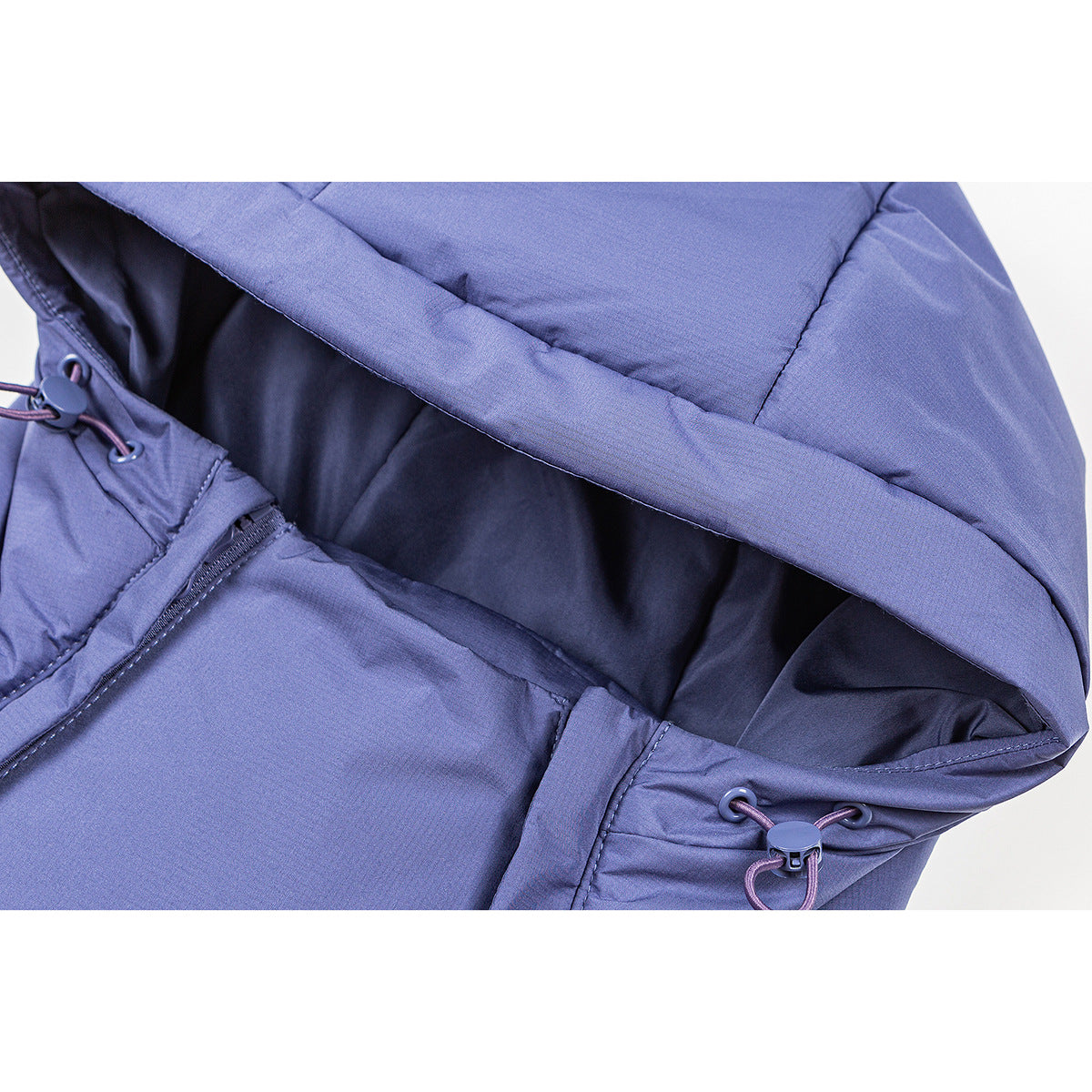 Close-up of a blue hooded jacket showing the dark lining and adjustable drawcords.