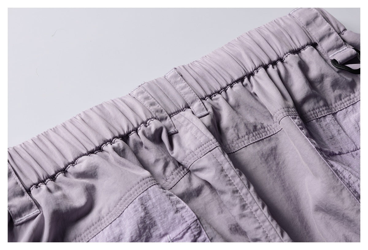 Close-up of mauve elastic waistband, belt loops, and pocket stitching.