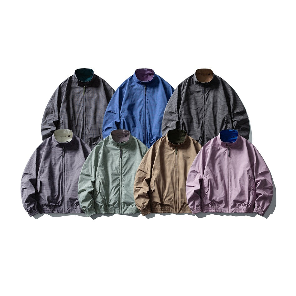 Seven zip-front jackets arranged in gray, blue, charcoal, lavender, sage, tan, and pink colorways.