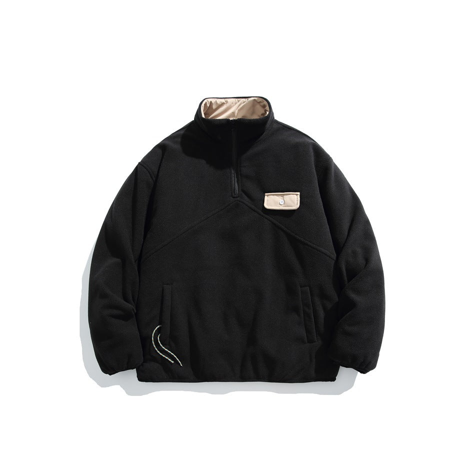 Black half-zip fleece-like jacket with beige collar lining and beige flap chest pocket, front flat lay