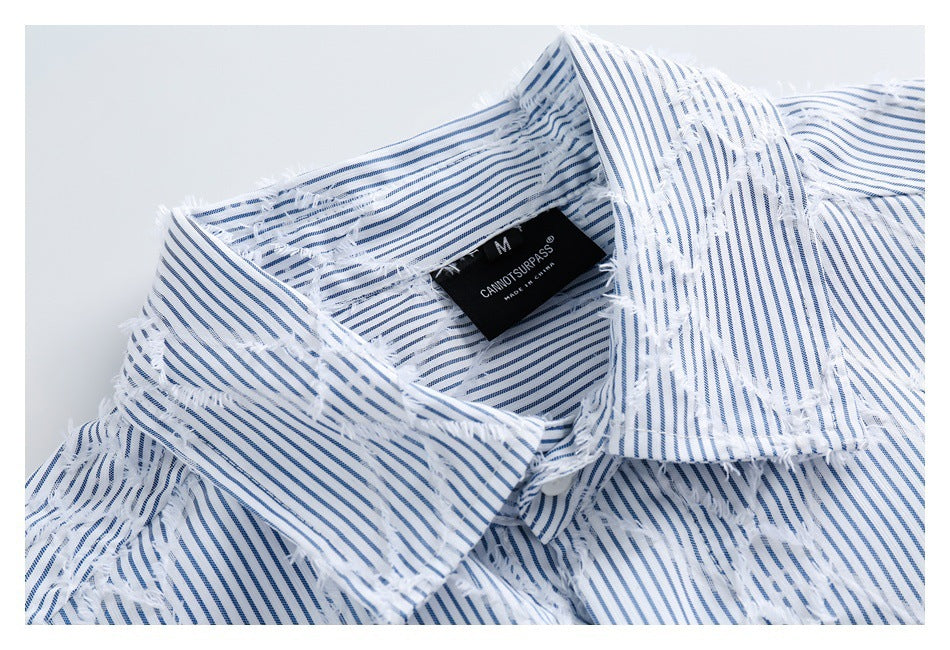 Close-up of the shirt collar, blue pinstripes, frayed fabric details, and sewn-in neck label.