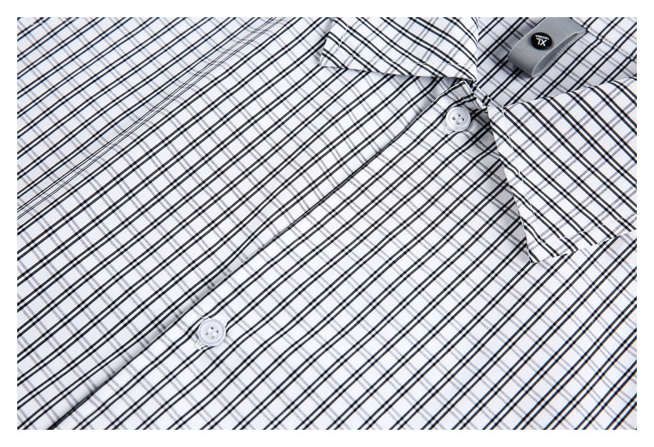 Close-up of the white-and-black check pattern, collar, buttons, and small fabric tab.