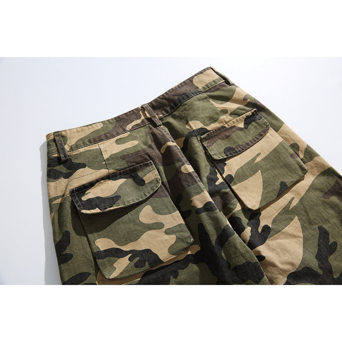 Close-up of the back waist and flap cargo pockets on olive, tan, brown and black camouflage pants.