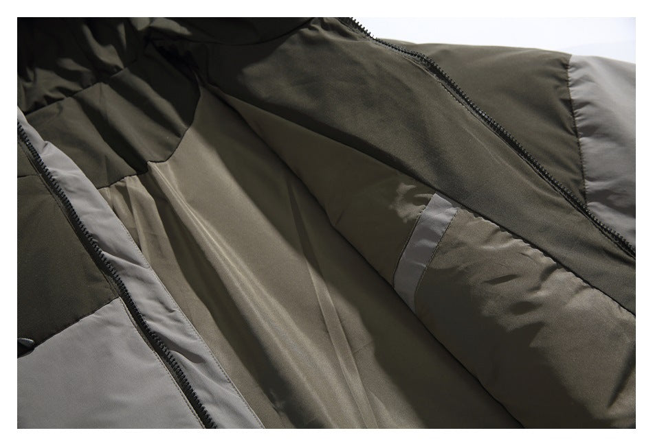 Close-up of an olive-gray jacket interior with a dark zipper and contrasting gray lining panels.