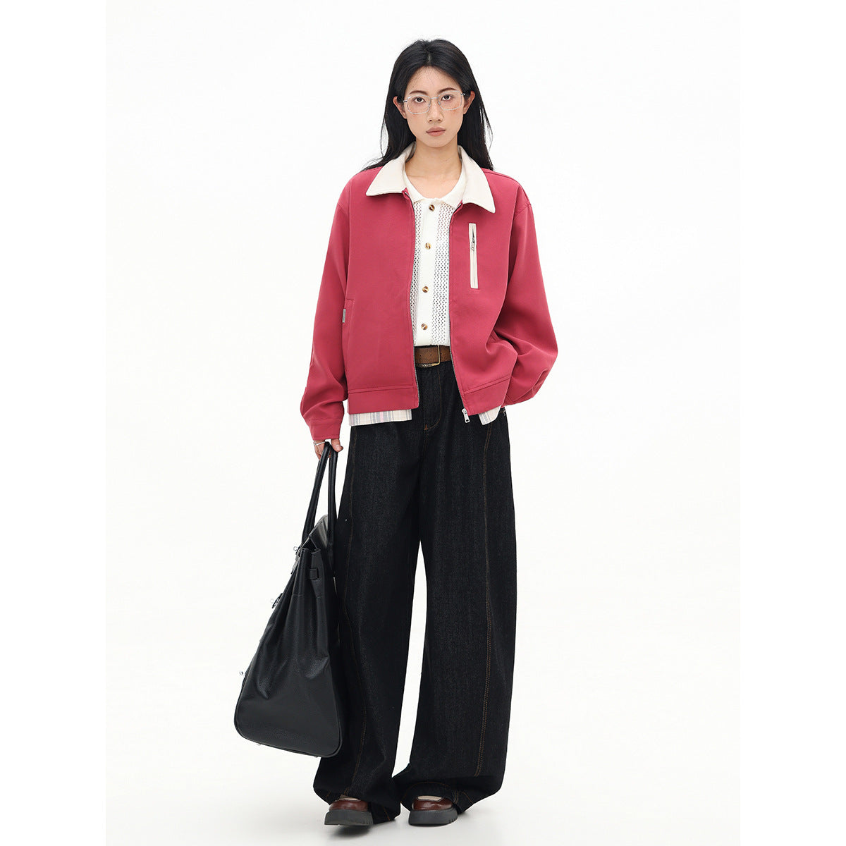 Model wearing an open rose-pink jacket with a cream collar, carrying a black tote bag.