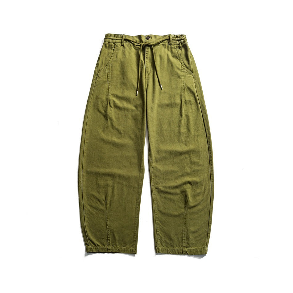 Front flat lay of olive-green wide-leg pants with an elasticated waistband, drawstring, button, and side pockets.