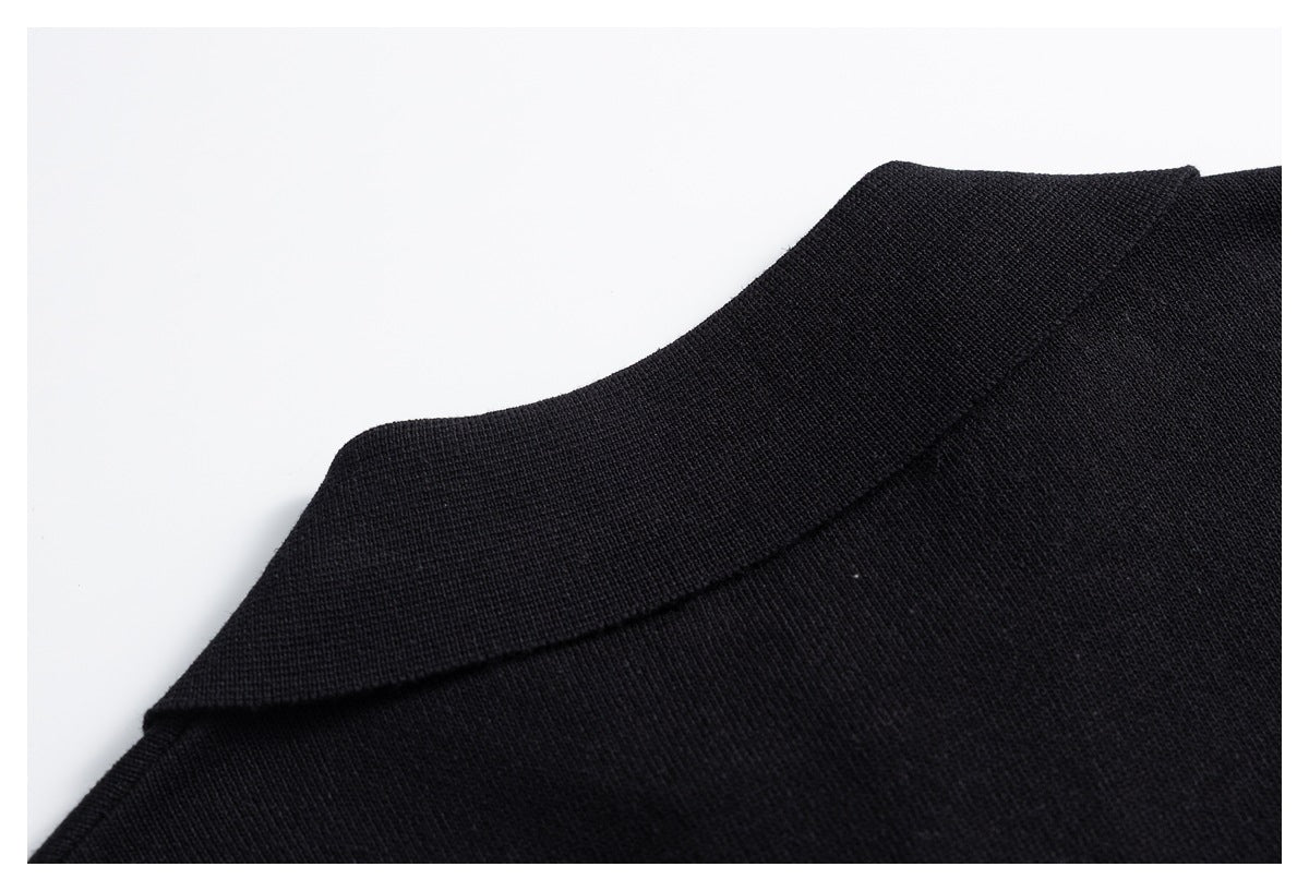 Close-up of a black knit garment collar and neckline.