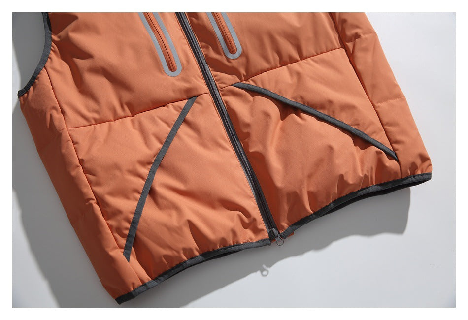 Close-up of an orange padded vest front with a dark center zipper, curved pocket trim and dark edging.