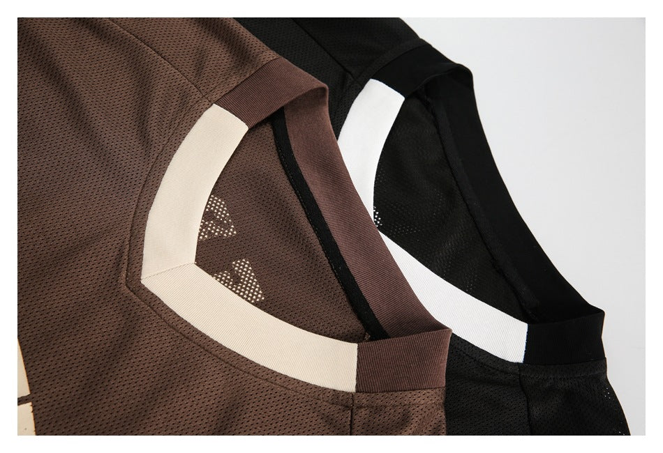 Close-up of the cream and white V-neck trim on brown and black mesh shirts.
