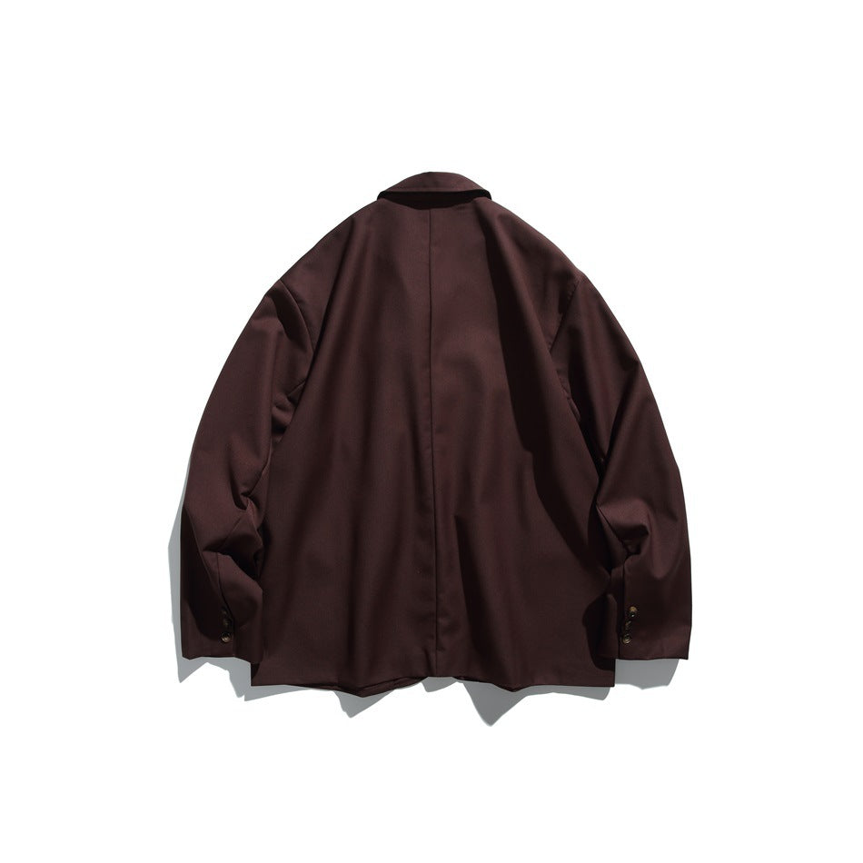 Back view of a dark brown blazer with a center seam and buttoned sleeve cuffs.