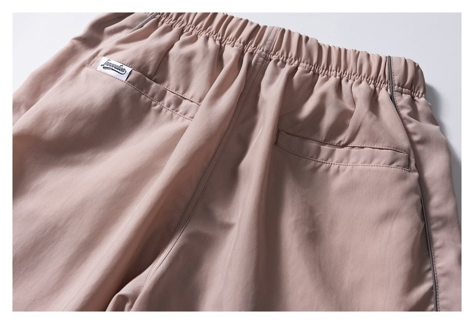 Close view of the pants' rear elastic waist and two pockets, including a small sewn label.