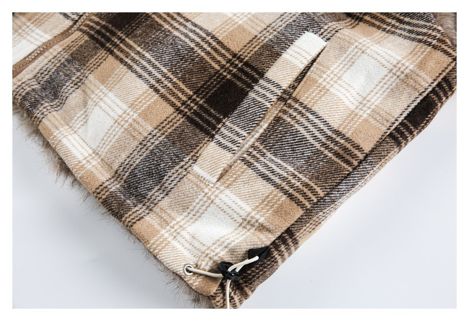 Close-up of a plaid coat pocket and hem with a cord adjuster and faux-fur edging.