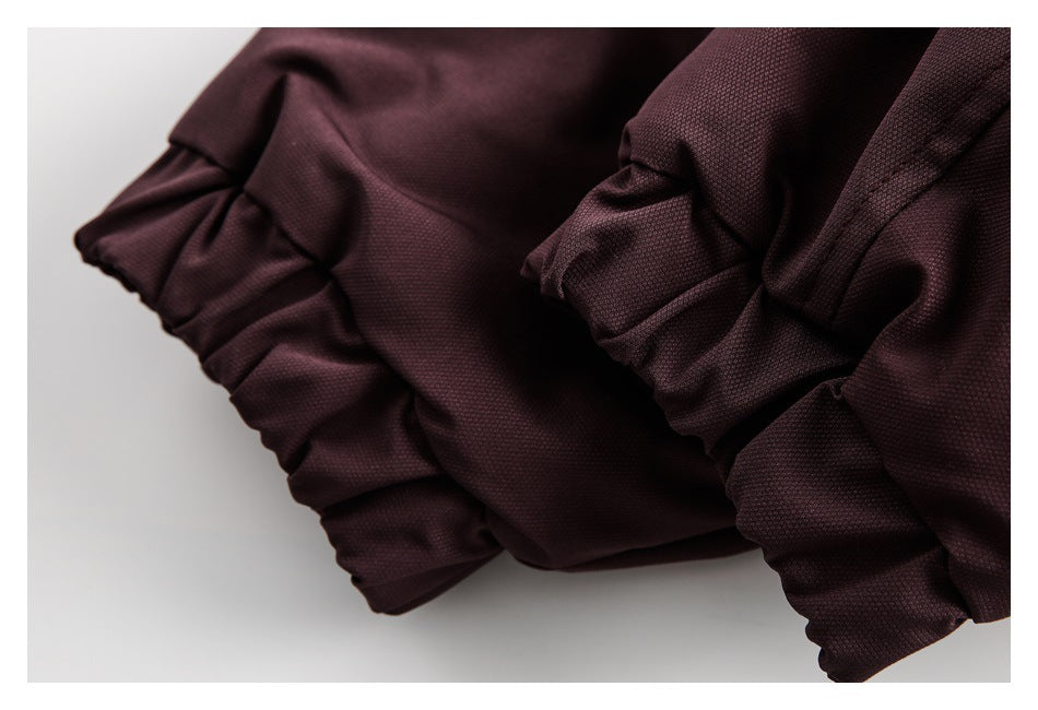 Close-up of gathered, elasticized edges on burgundy textured fabric.