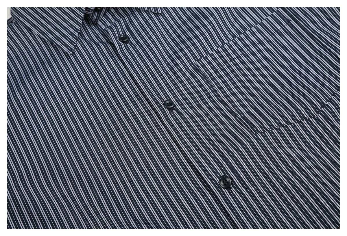 Close-up of a navy-and-white striped shirt front with dark buttons and a single chest pocket.