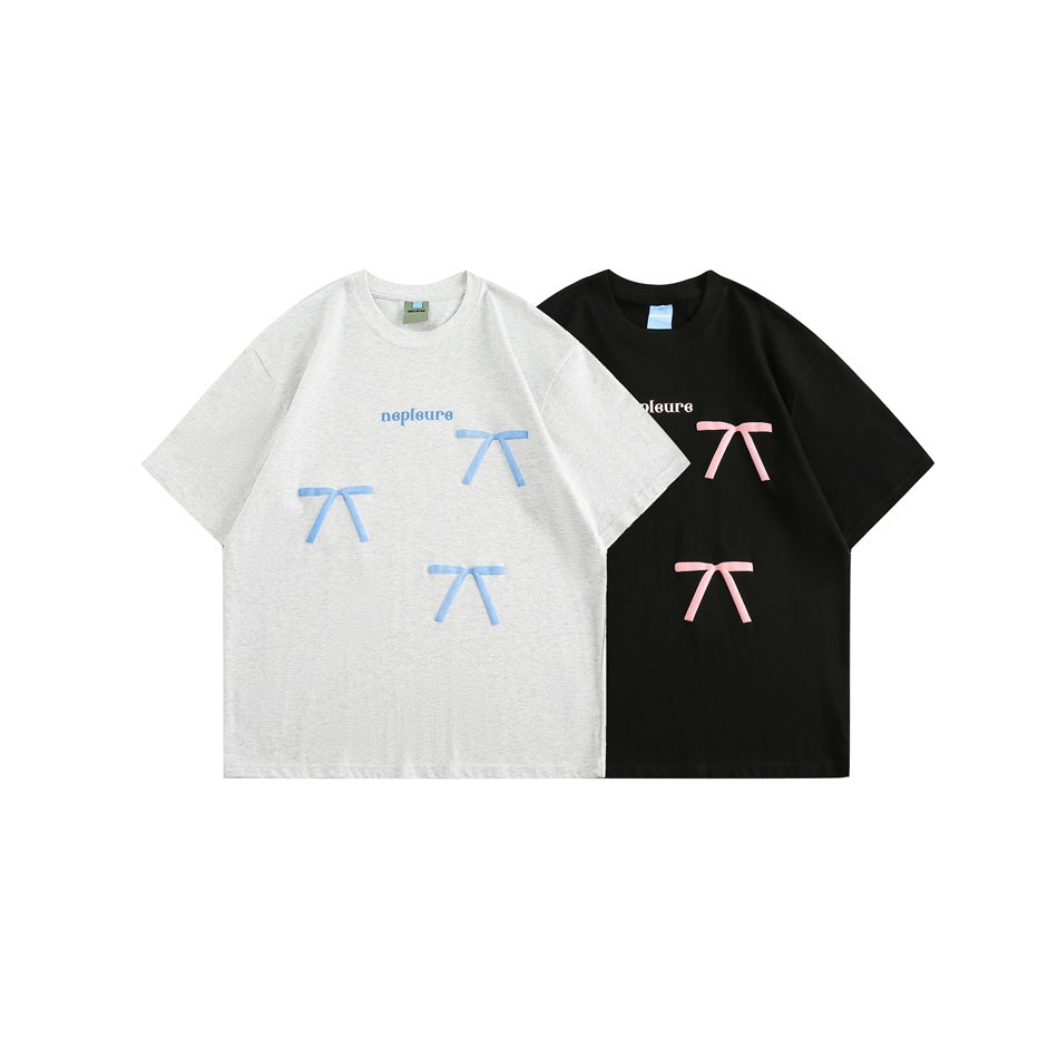 Front view of light gray and black short-sleeve T-shirts with contrasting bow prints and small wordmarks.
