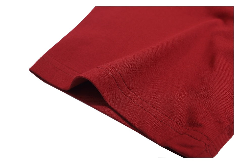 Close-up of the red T-shirt’s sleeve hem and stitching.