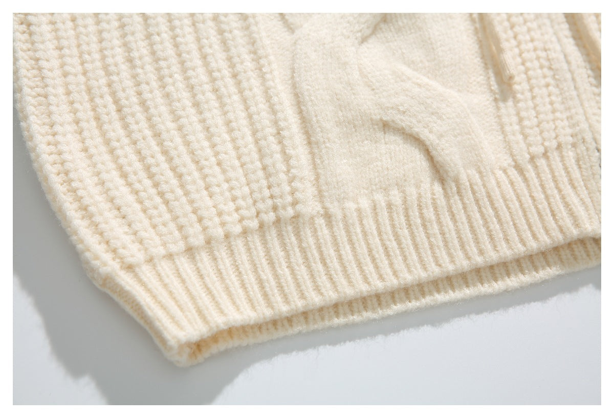 Close-up of the ivory cardigan's textured knit and ribbed hem.
