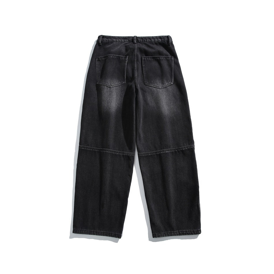 Flat view of the back of black wide-leg jeans with two patch pockets and horizontal knee seams.