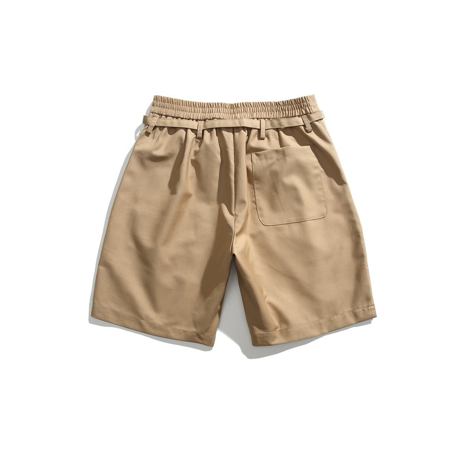 Back view of tan shorts with an elastic waistband, belt loops, and a single patch pocket.