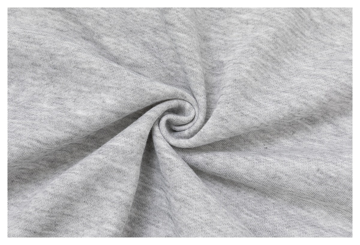 Close-up of light gray garment fabric twisted into a spiral fold.