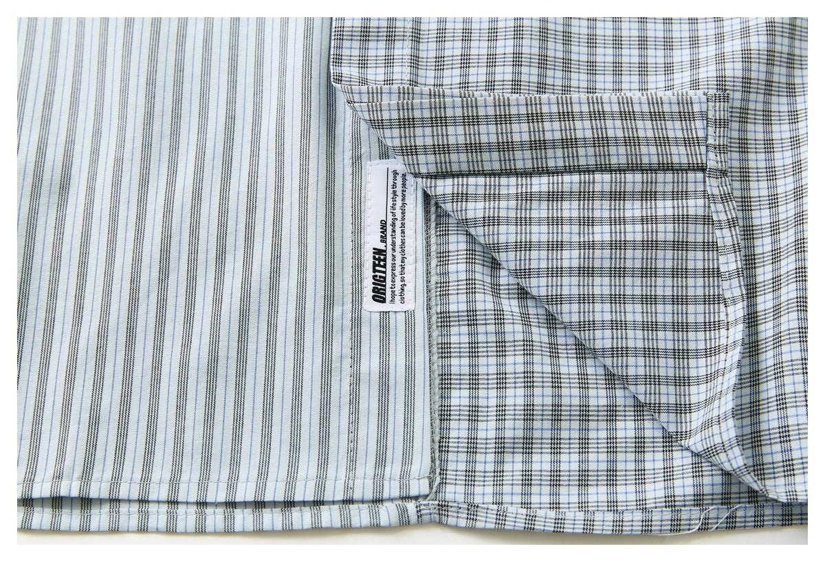 Close-up of the shirt's striped and plaid panels, with an interior sewn label visible.