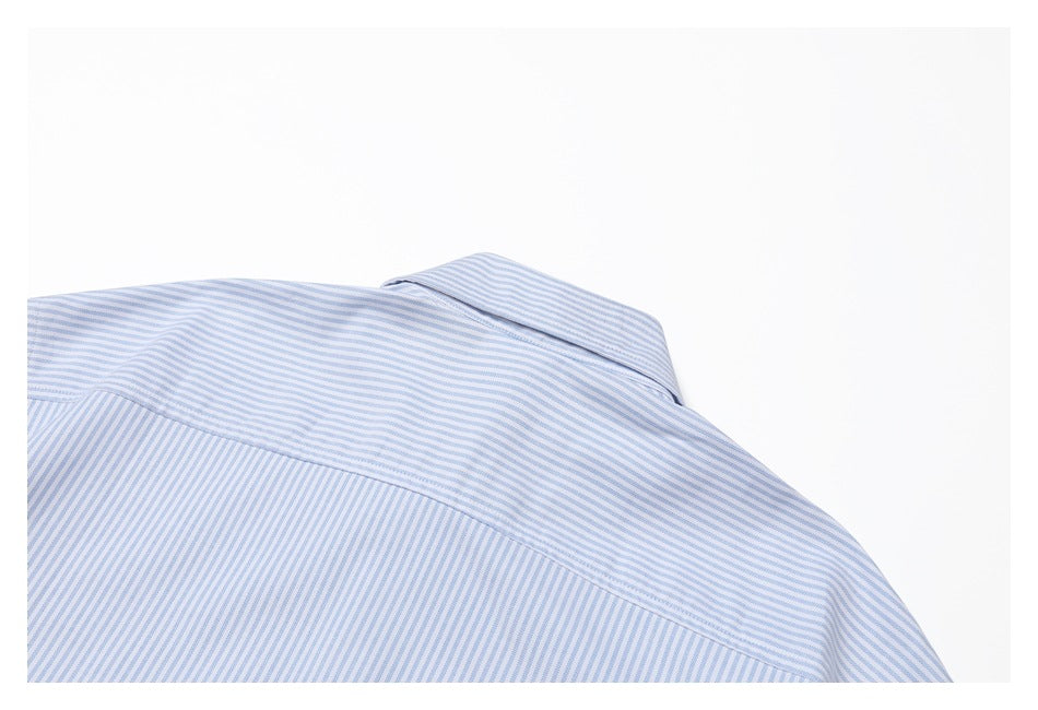 Cropped back view of a light blue and white striped shirt, showing the collar and shoulder yoke.