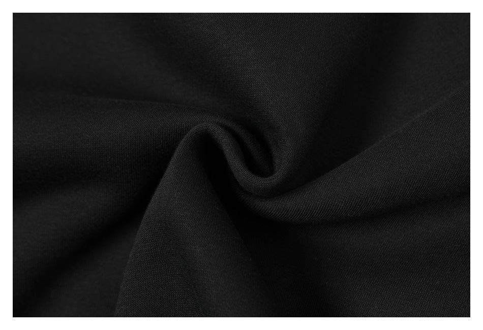 Close-up of black fabric gathered into a soft fold, showing its surface texture.