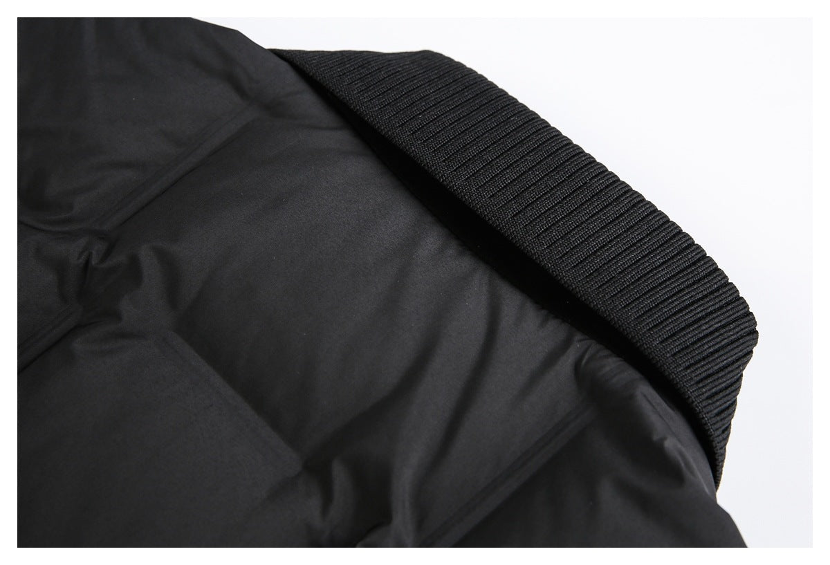 Close-up of a black jacket's ribbed trim and smooth inner fabric.