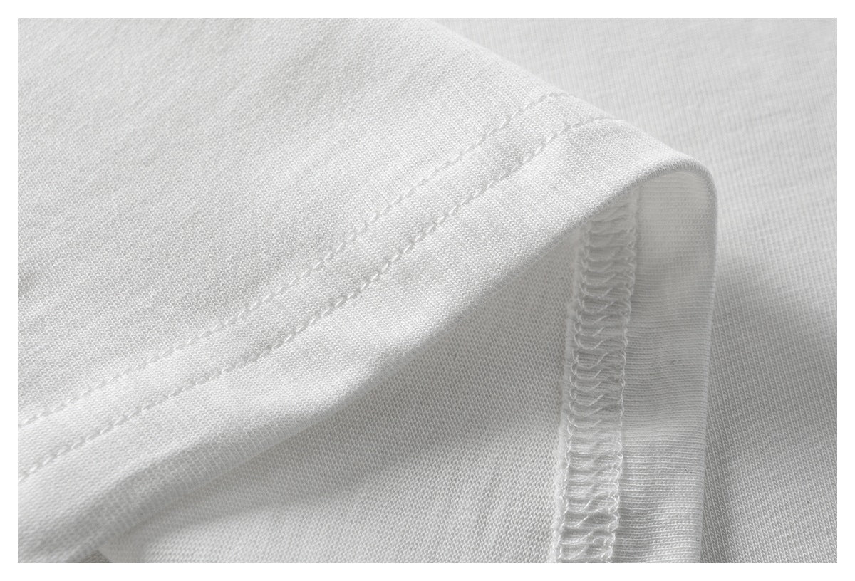 Close-up of a white T-shirt hem with double stitching and an overlocked inside seam.
