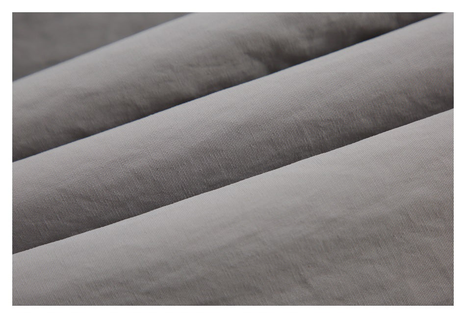 Close-up of folded light gray fabric showing its surface and folds.