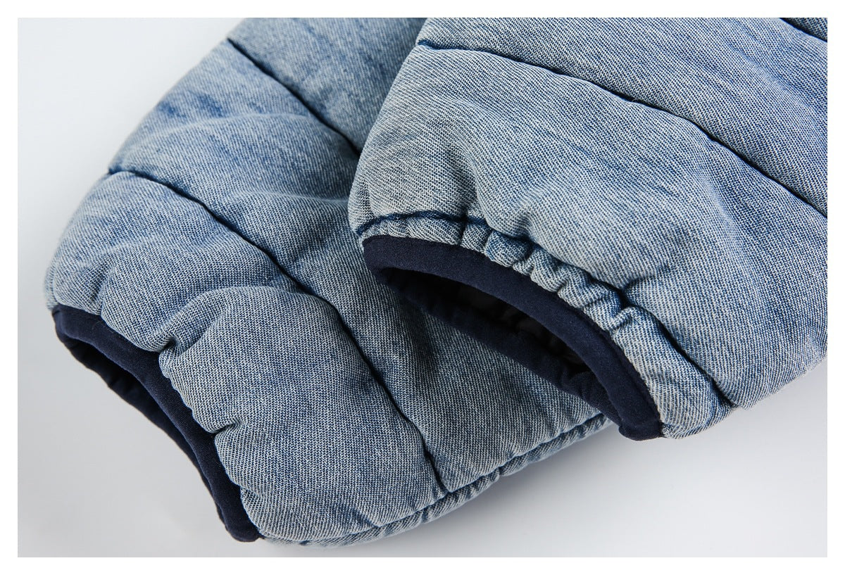 Close-up of a gathered jacket opening with dark navy lining and light blue quilted fabric.