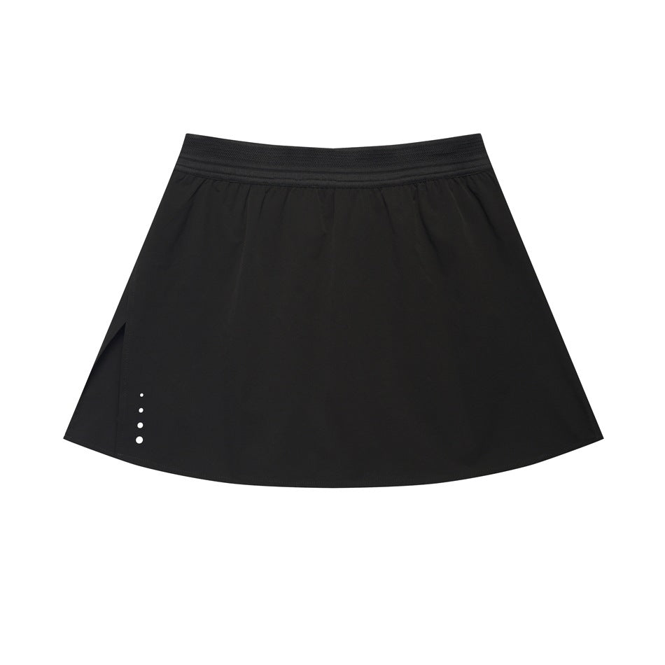 Black A-line mini skirt with wide elastic waistband, gathered waist, side slit and small dots at the hem
