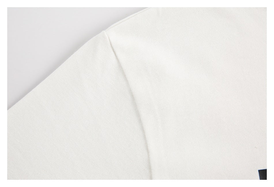 Close-up of the shoulder seam on a white T-shirt.