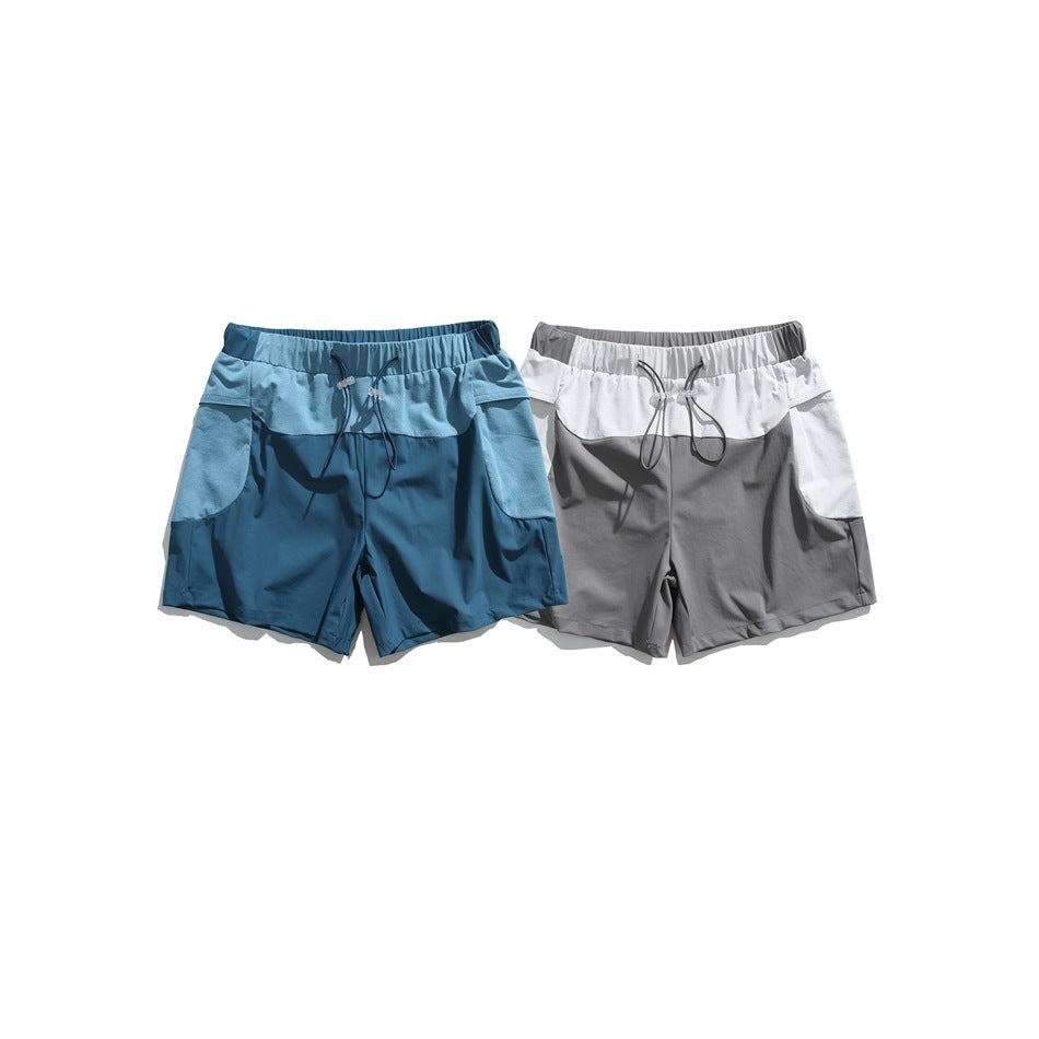 Two pairs of shorts shown from the front: one blue and one gray with white perforated panels and drawcord waists.