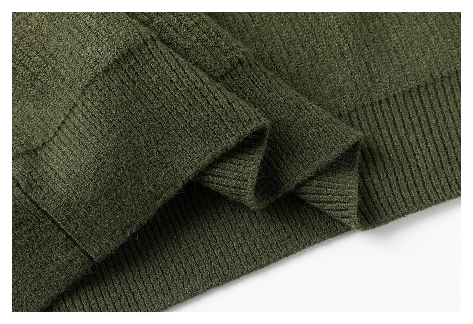 Close-up of an olive green rib-knit garment edge folded over itself.