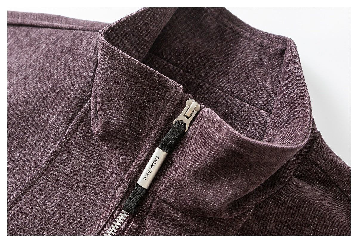 Close-up of a plum textured jacket collar and silver zipper with a black pull tab.
