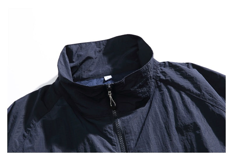 Close-up of the jacket's raised collar and front zipper with a dangling pull.