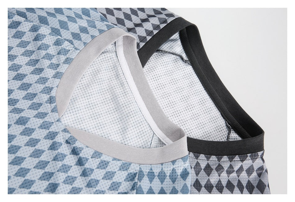 Close-up of blue and charcoal diamond-patterned shirts showing their contrasting V-neck trims and inner mesh panels.