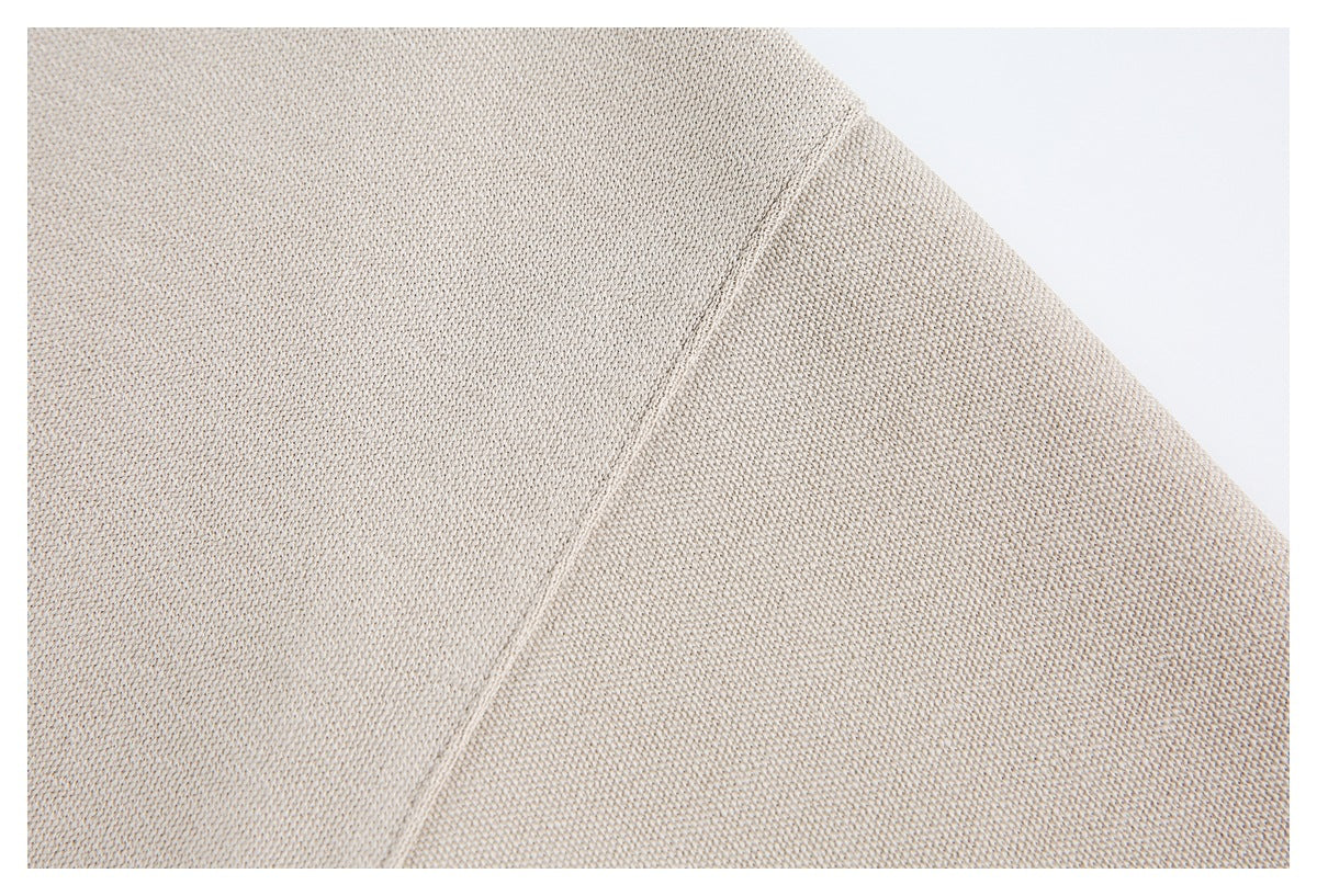 Close-up of beige knit fabric showing a diagonal seam.