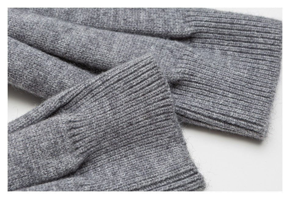Close-up of gray knit sweater sleeves and wide ribbed cuffs.