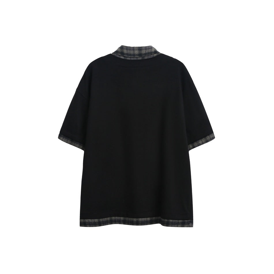 Back of a black short-sleeve collared shirt with gray plaid trim at the collar, cuffs, and hem.