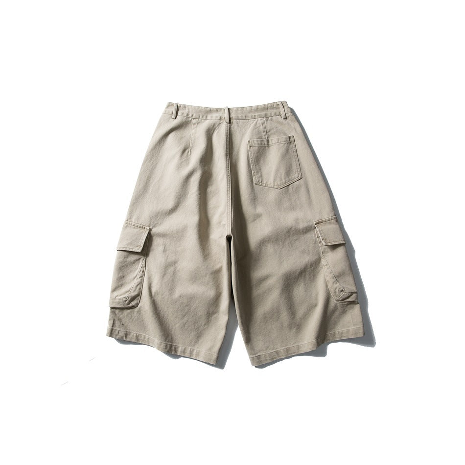 Back view of light beige cargo shorts with a single back pocket and flap pockets on both legs.