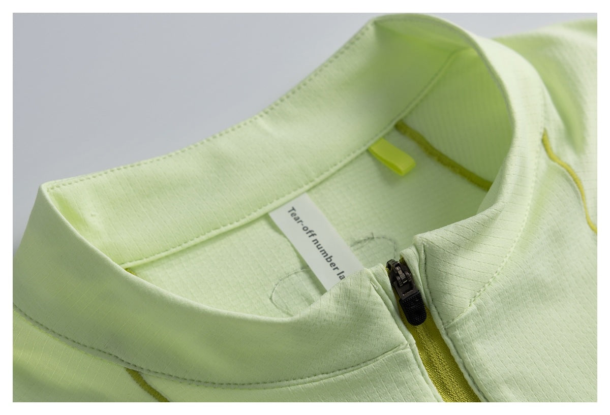 Close-up of a pale lime garment collar, yellow-green zipper, and an interior English label.