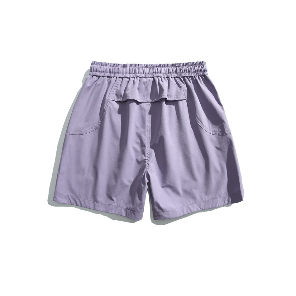 Back view of lavender shorts with an elastic waistband, two curved pockets, and a small flap pocket.