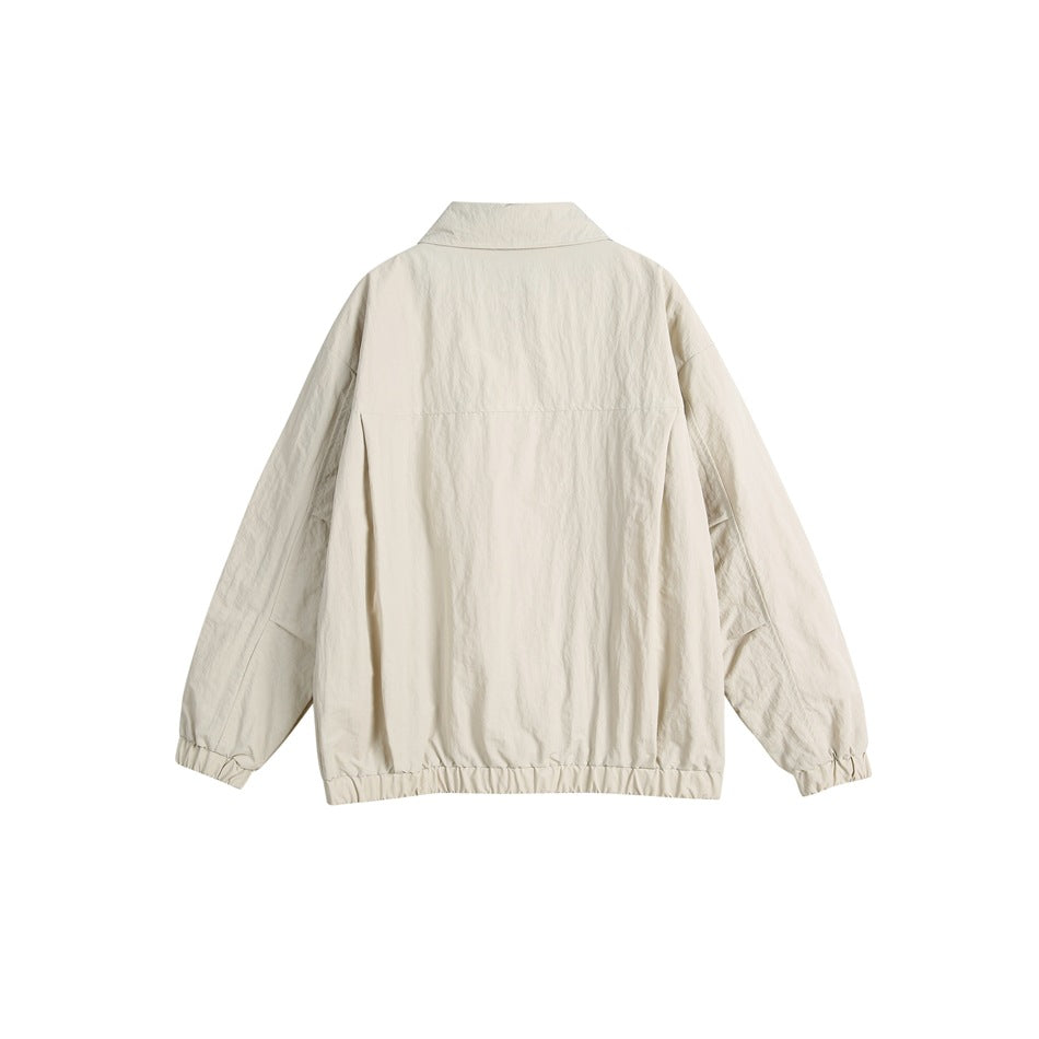 Back view of an off-white jacket with a collar, long sleeves, elastic cuffs and gathered elastic hem.