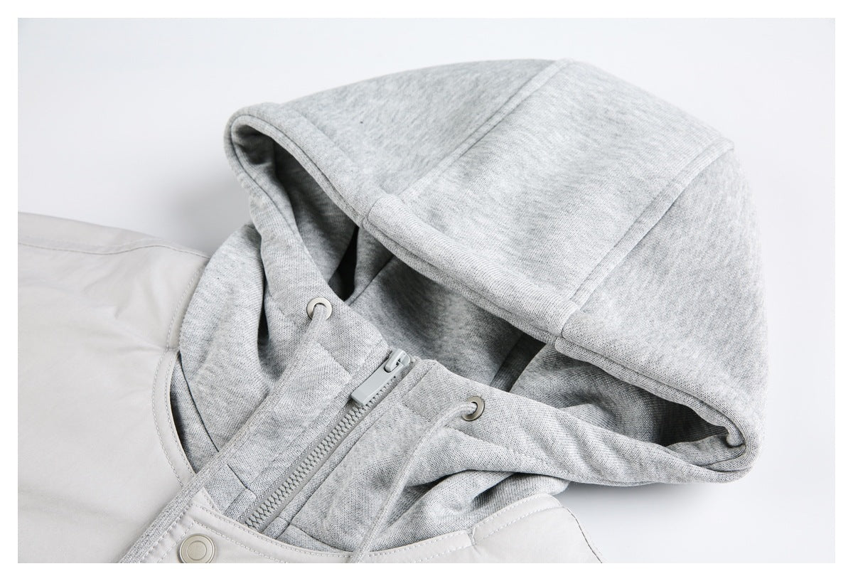 Close-up of a light gray jacket's paneled hood, drawstrings, eyelets, and zipper.