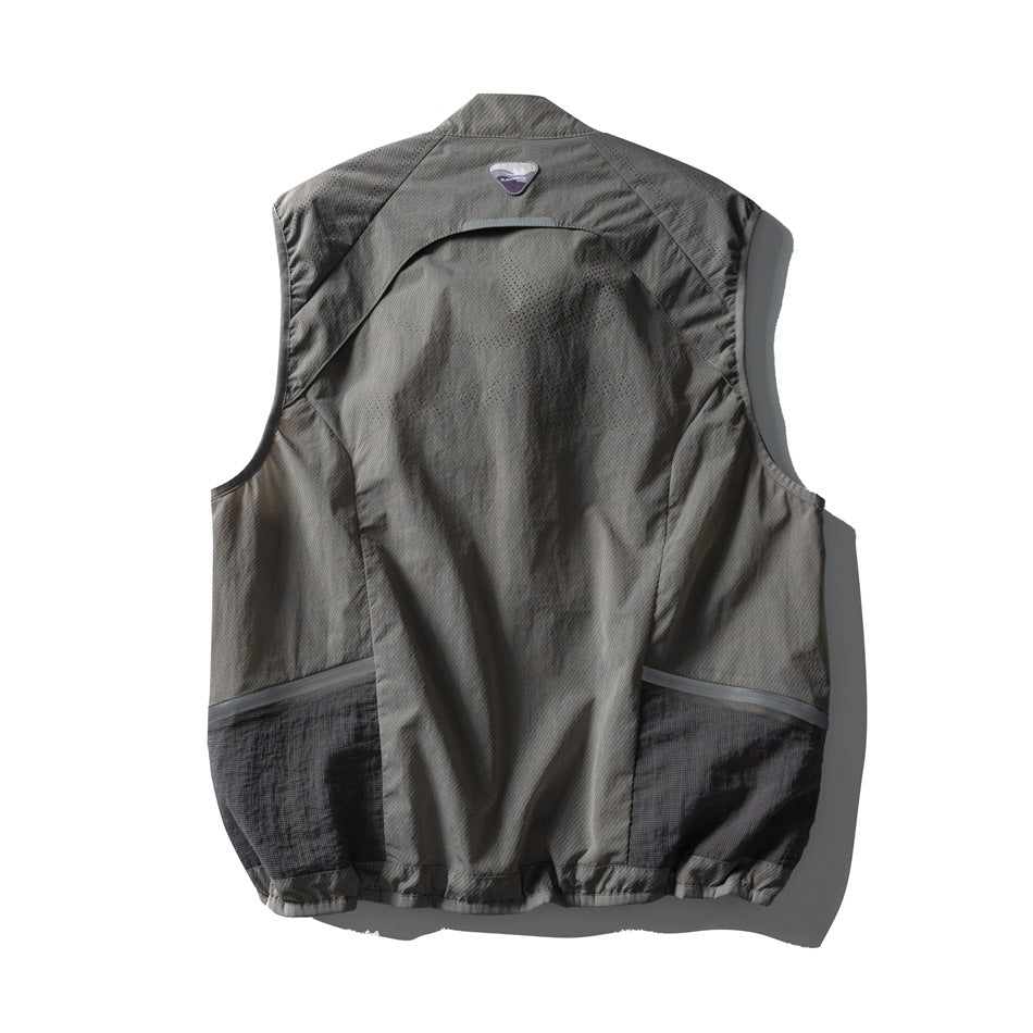 Back view of a gray sleeveless vest with perforated panels and dark lower side sections, laid flat on white.
