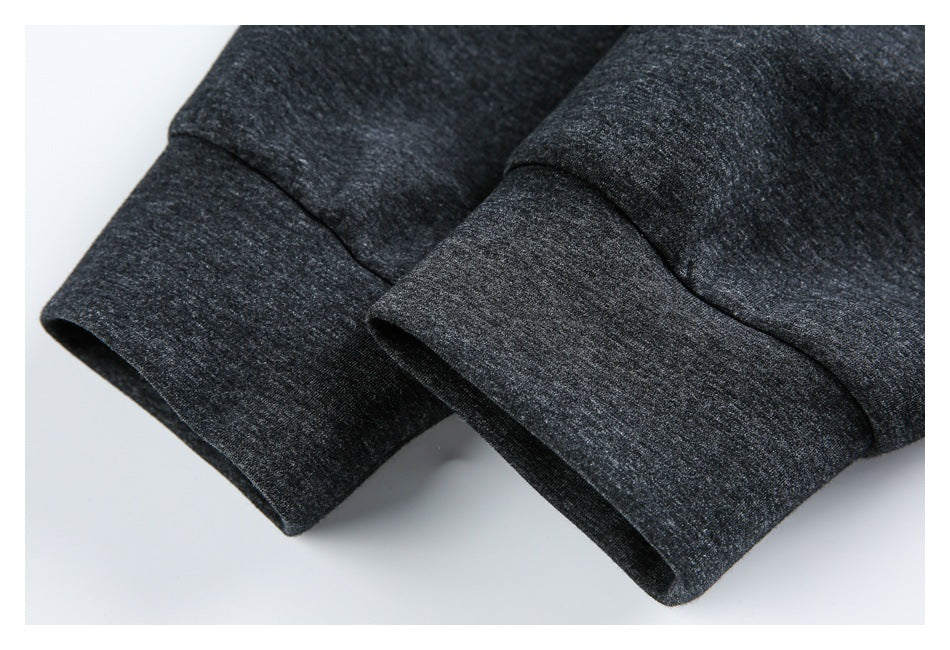 Close-up of two charcoal heather sleeve cuffs and their stitched seams.