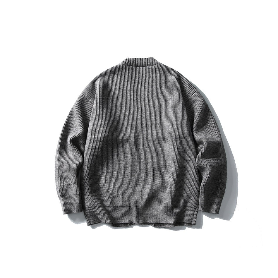 Back view of a gray rib-knit cardigan laid flat against a white background.